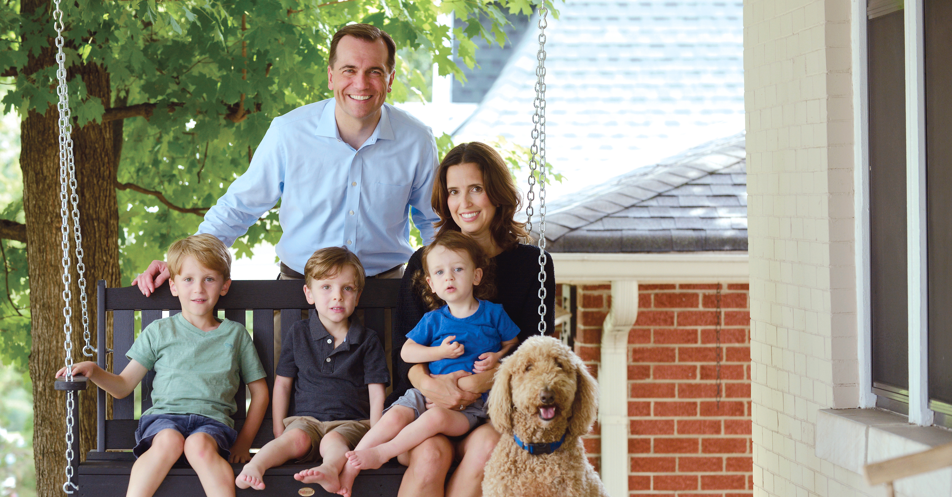 Portrait of John Ray Clemmons & his family on their front porch.