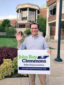 John Ray Clemmons holds his campaign sign and waves hello.